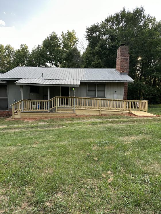 Single-story home with a newly built wood deck and railing